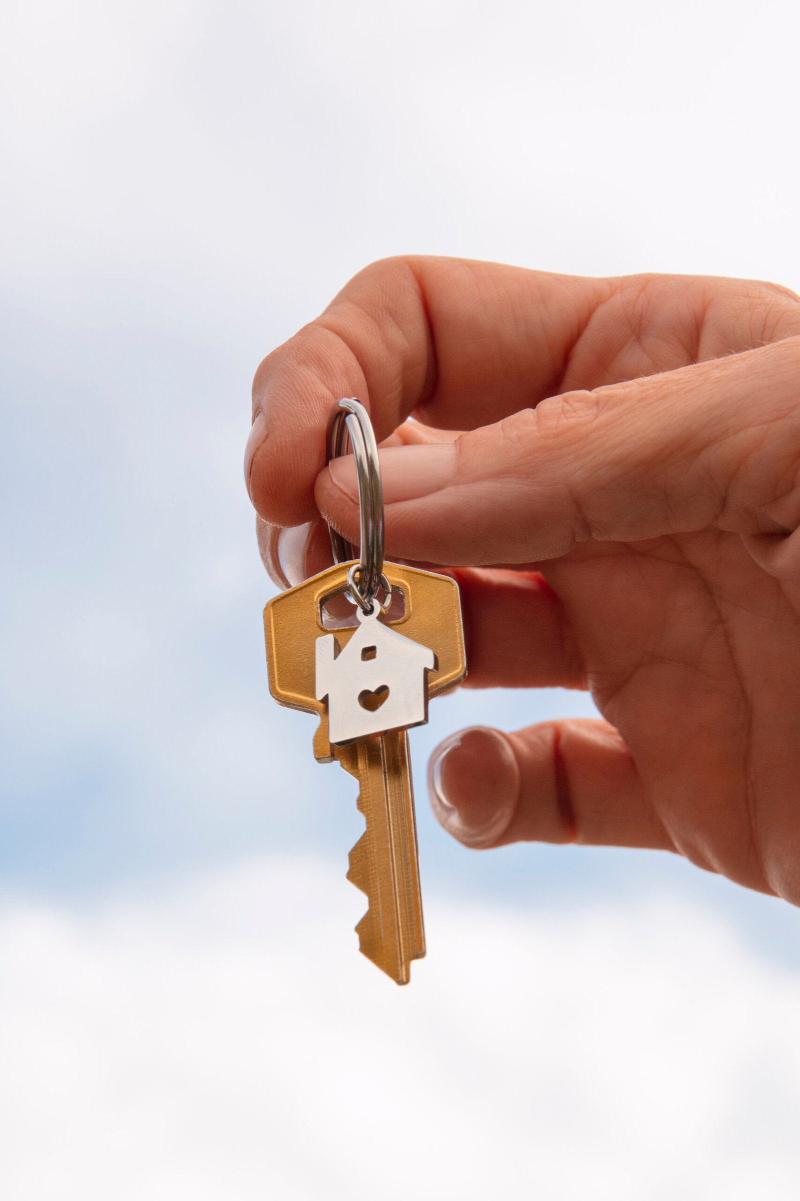 hand-holding-key-outdoors